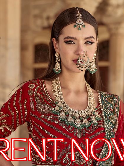 Rent our gorgeous bridal jewellery to make your moments memorable. This model pairs a heavy emerald and Kundan set with a traditional red lehenga for a stunning look.