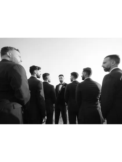 A creative group shot of the groomsmen surrounding the groom. This perspective creates a sense of unity and focus on the man of the hour.