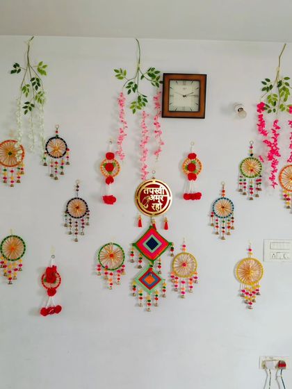 Another angle of the Tapasvi welcome decor, showing how the handmade wall hangings and garlands can transform an entire wall into a celebratory space.