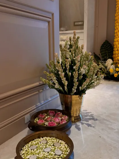 Details that make a house a home. For this Griha Pravesh, we placed brass urlis at the entrance, one filled with floating jasmine and candles, and the other with lotus buds.