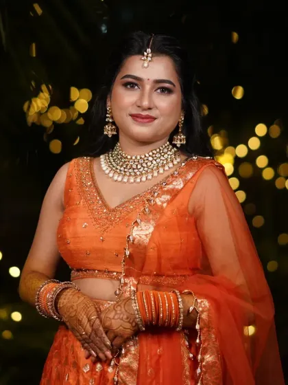 Sangeet night is all about color and energy. I created this vibrant look with a flawless base that lasts through all the dancing, complemented by a kundan jewelry set and a bright orange lehenga.