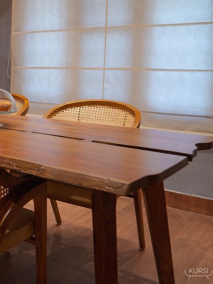 A view across the live-edge dining table, showing the natural imperfections and splits in the wood that make each piece one-of-a-kind.