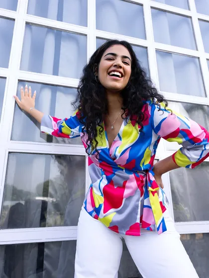 Color can completely change your mood, and I’m a huge believer in dopamine dressing. This is from a professional campaign I styled and modeled for, showing how to pair a vibrant, multi-colored top with simple white pants for a look that’s joyful and sophisticated.