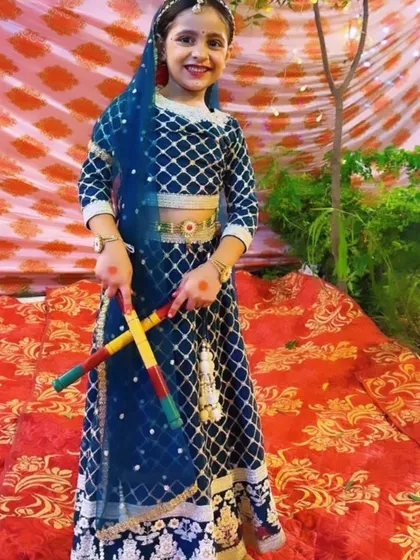 Getting ready for a Dandiya performance. Our kids learn various folk dance forms, complete with props and traditional costumes.