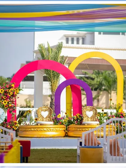 The festive Haldi seating area, framed by white benches and colorful decor, ready for a morning of celebration.