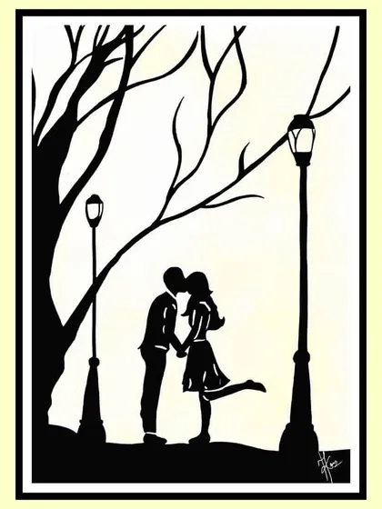A silhouette of a couple sharing a romantic moment under a streetlamp. It’s about that unexplainable connection, a quiet moment that feels like it's just the two of you in the world.
