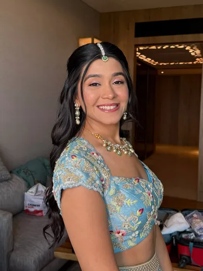 A candid moment showing her beautiful smile. The makeup is designed to be comfortable and long-lasting, allowing the bride to enjoy her day without any worries.
