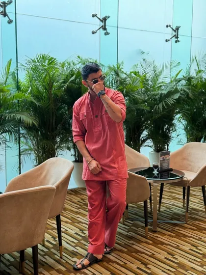 A more dynamic pose in the red kurta, showing how comfort and style can go hand in hand.