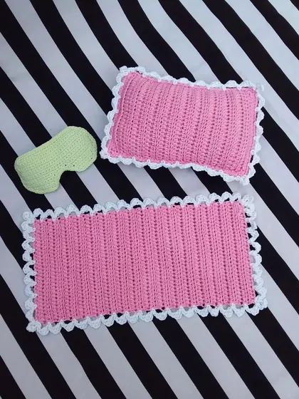 This set was a special custom order I made. It includes a miniature pink crochet blanket with a white scalloped edge, a matching pillow, and a tiny green eye mask. I really enjoy working on custom projects like this to bring your ideas to life.