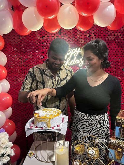 A happy couple cutting their cake during a private theatre celebration.