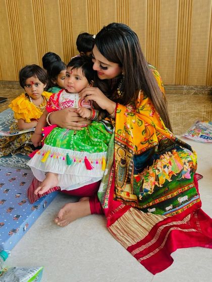 Another sweet moment from a Kanjak puja, with the little girl dressed in our vibrant, personalized ethnic wear.