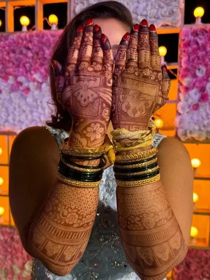 A full view of the bride's hands and arms, showing the consistent, dark stain from the palms to the elbows.