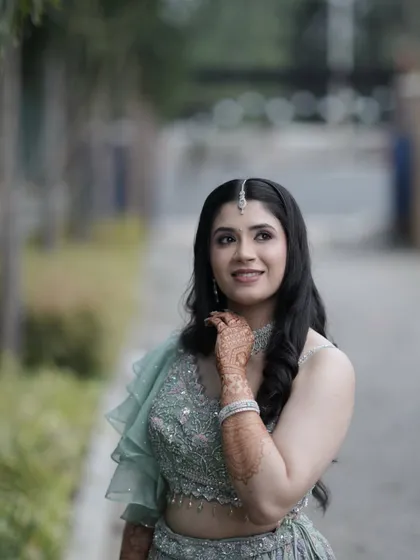 Grace in every detail. This bride looks ethereal in her pastel green lehenga for her Sangeet. The makeup is soft and romantic, with a focus on her glowing skin and bright smile.