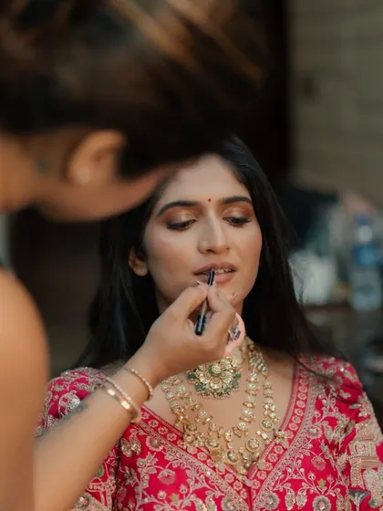A behind the scenes shot of me applying the final touches to the bride's lipstick.