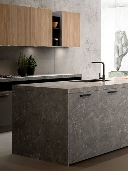 This kitchen makes a bold statement with stone-finish cabinetry. This unique material choice offers the raw, textured look of natural stone while providing the durability and functionality of modern modular design.