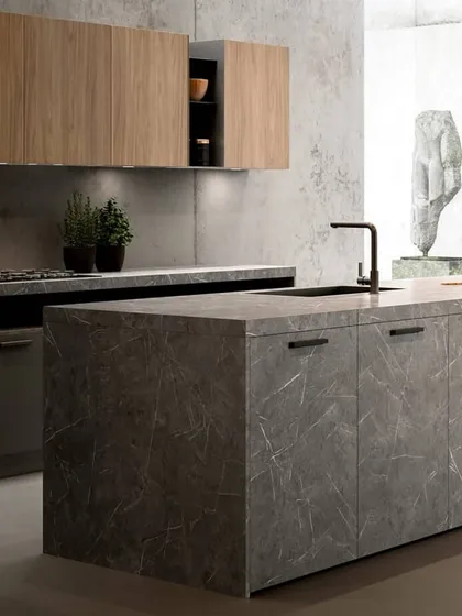 This kitchen makes a bold statement with stone-finish cabinetry. This unique material choice offers the raw, textured look of natural stone while providing the durability and functionality of modern modular design.