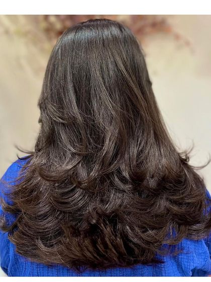 The back view of the layer cut, showing how the layers create a beautiful, cascading effect and add fullness to the hair.