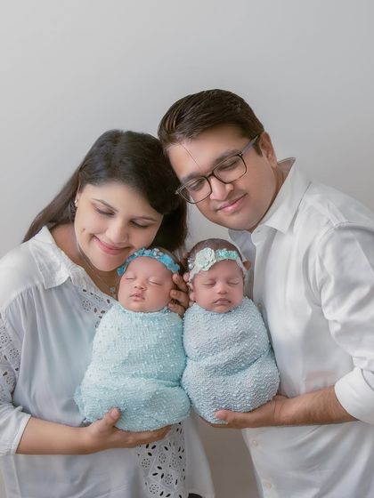 The complete family. New parents holding their twin baby girls, a beautiful portrait of a family that has just doubled in love.