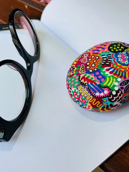 Another look at the 'joy pebble'. The intricate, colorful patterns are all done freehand, making each paperweight a one-of-a-kind creation.