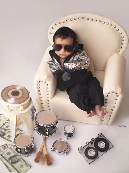 How adorable is this little DJ baby? With his cool shades and tiny drum set, he's ready to drop the cutest beats.