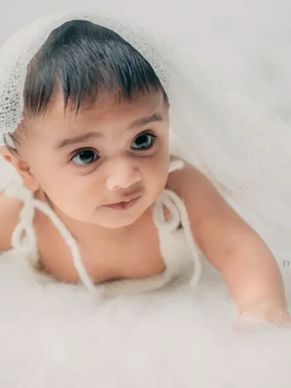 A beautiful, dreamy portrait of this 5-month-old. The soft white textures create a heavenly and angelic feel.