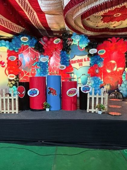 A large-scale superhero stage setup for an action-packed birthday. We created a city skyline backdrop and used bold red and blue decor elements to bring the comic book world to life for the young heroes.