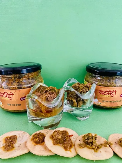 Mathris topped with my homemade pickles. This picture perfectly captures a delicious and traditional Indian snack.