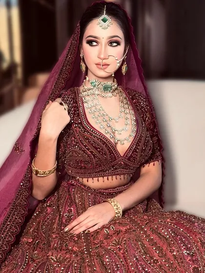 Merging elegance with royalty. This bride looks absolutely stunning with her dramatic eye makeup and regal posture, ready for her big day.
