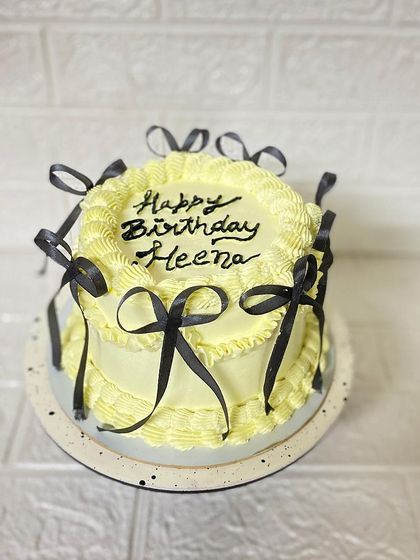 A full view of the Heena's birthday cake, showcasing the popular bow design.
