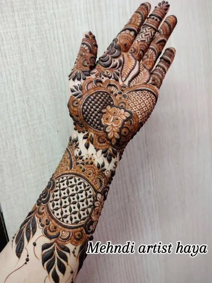 A complex design featuring geometric grids, hearts, and floral elements, perfect for a bride who wants a bit of everything in her henna.