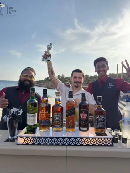 Our team celebrating a successful beachside event. We bring top-shelf spirits and top-tier service, no matter the location.