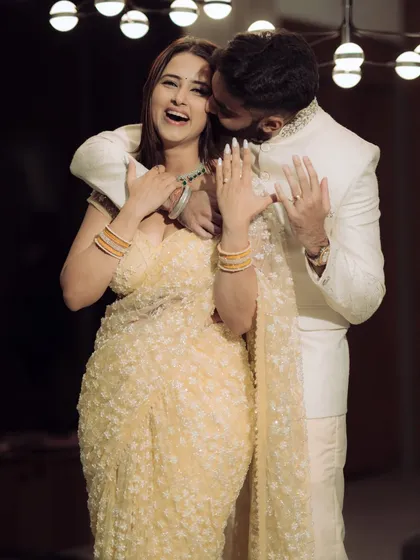 A moment of pure joy and laughter during an indoor engagement celebration. The warm lighting and genuine expressions make this a perfect blend of candid emotion and cinematic style.