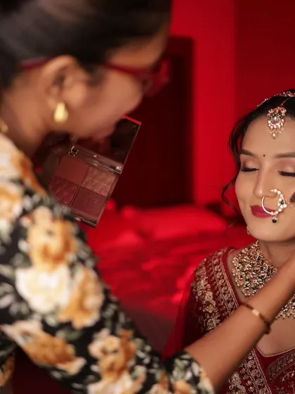 A behind-the-scenes shot of me working on the bride's makeup, ensuring every detail is perfect.