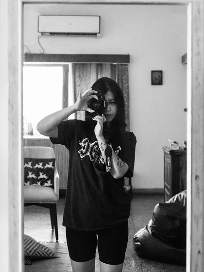 A black and white self-portrait in the mirror. This is me, in my space, with my camera. It’s a moment of reflection on my own craft.