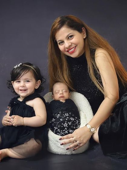 A precious moment between a mother, her toddler, and her newborn baby. Sibling photos with a new arrival are so special and capture the start of a lifelong bond.
