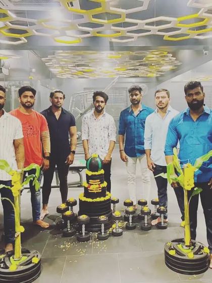 The full team celebrating a gym milestone. We believe in marking our progress and enjoying the journey together. This is the spirit of our fitness family.