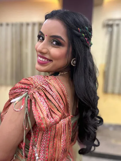 Another angle of this vibrant Mehendi look. The makeup is flawless and the hairstyle adds a touch of playful charm.