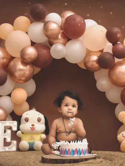 A moment of delicious discovery. This little one is enjoying every bit of his first birthday cake during his studio photoshoot.