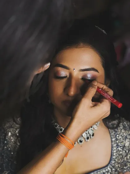 A behind-the-scenes shot of me bringing the sparkle to this bride's reception look.