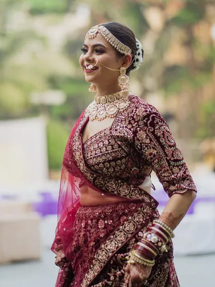 A joyful, candid shot of the bride. Her natural smile and glowing makeup capture the happiness of her wedding day.