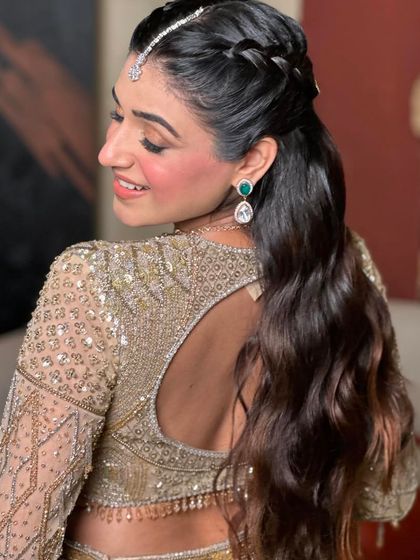 A side view of the half-up braided style, showing the intricate detail of the braids and the soft waves.
