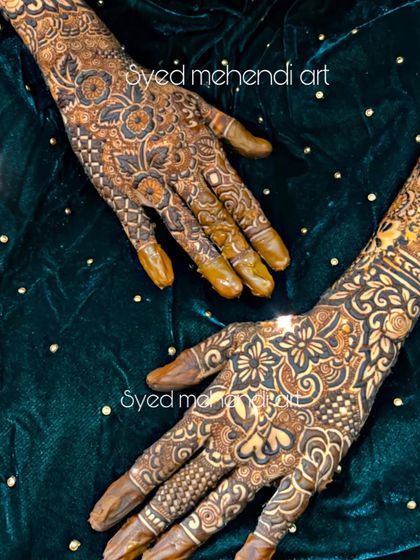 A top-down view of a bridal design, showing the intricate work on the back of the hands.