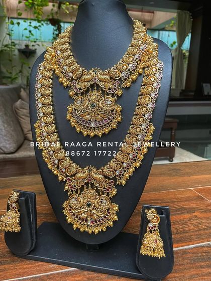 A beautiful peacock-themed bridal set in an antique finish. Both the choker and the long haram feature intricate peacock motifs studded with Kemp stones.