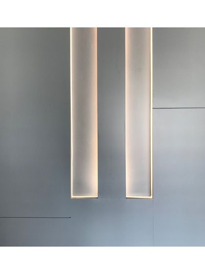 This detail shows integrated profile lighting within a wall panel. This technique provides soft, ambient light and creates a clean, architectural feature that enhances the minimalist feel of the room.