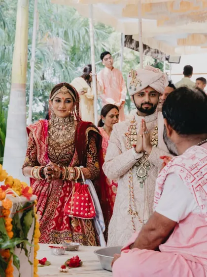 The couple seeking blessings from the priest during their wedding ceremony. We coordinate with the priests to ensure all rituals are performed smoothly and traditionally.