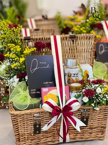 This grand wicker hamper, filled with flowers and gifts and tied with a large ribbon, is a perfect example of a bespoke creation designed to make a statement and create a lasting memory.