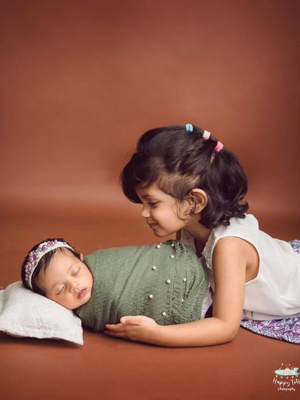 Capturing the gentle curiosity of an older sister meeting her new sibling. These are the memories that families will cherish forever.