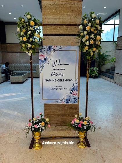 A custom welcome sign for a "Little Prince" naming ceremony, flanked by elegant floral arrangements. This is how I ensure every detail of your event is personalized and beautiful.