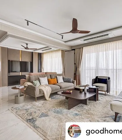 This living room, featured in Good Homes Magazine, demonstrates a balance of form and function. The neutral palette is warmed by wooden ceiling fans and a mix of comfortable, stylish furniture.