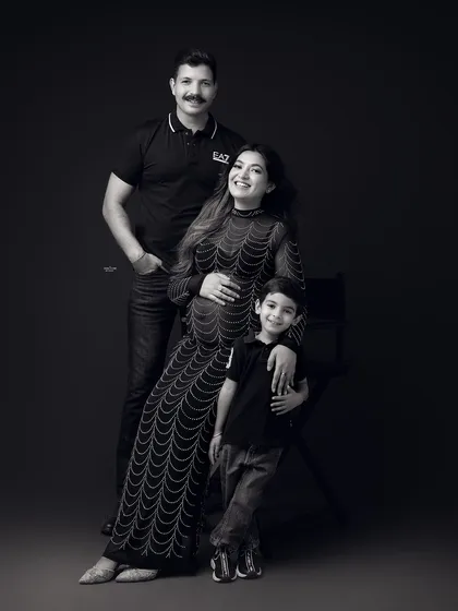 A stylish black and white family portrait. This family's got swag. The coordinated black outfits look so chic and modern.